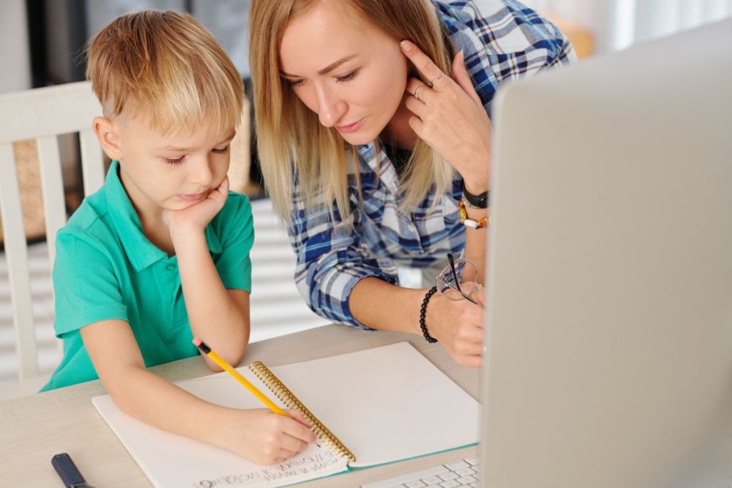 Mother explaining preteen son difficult topic and helping him with homework