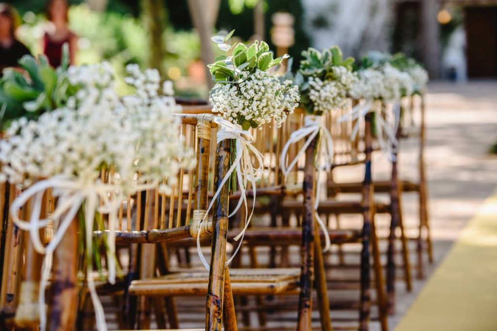 Floral arrangements for empty chairs for a wedding ceremony in spring