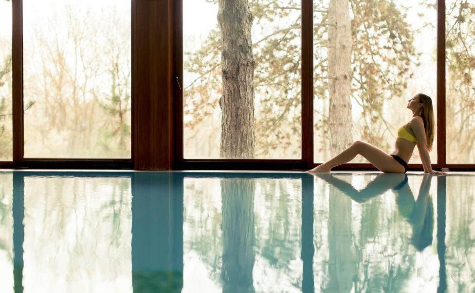 young-woman-sitting-by-the-swimming-pool-2023-11-27-05-30-26-utc (1)