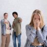 European and african american teens zoomers guys laugh at crying female with backpack in school or college