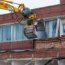 Demolition of an old building with a long reach machine hydraulic jaw. Regeneration of a space for new, modern building. Everything You Need to Know About Commercial Demolition